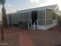 Mobile home exterior features a covered porch and landscaped yard at 16680 W Val Vista Rd # 146, Casa Grande, AZ 85122