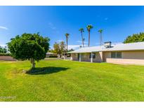 Large backyard with grassy area and partial view of home at 18001 N 99Th Dr, Sun City, AZ 85373