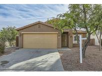 Beige house with a two-car garage and a landscaped front yard at 25763 W Satellite Ln, Buckeye, AZ 85326