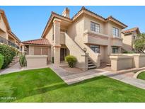 Attractive two-story condo building with landscaping and walkway at 9711 E Mountain View Rd # 1516, Scottsdale, AZ 85258