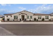 Single-story home with a Spanish-style facade and landscaped front yard at 10986 N Northfield St, Surprise, AZ 85388