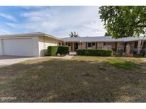 Single story home with attached garage and front yard at 13837 N Tumblebrook Way, Sun City, AZ 85351