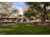 Stunning Spanish-style home with lush landscaping and a gated entrance at 8145 N 68Th St, Paradise Valley, AZ 85253