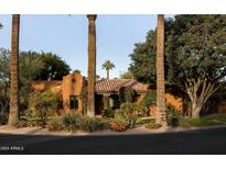 Charming Spanish-style home with mature landscaping and a welcoming front porch at 1603 Palmcroft Se Dr, Phoenix, AZ 85007