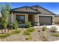 One-story home with gray exterior, two-car garage, and desert landscaping at 5515 N 193Rd Ave, Litchfield Park, AZ 85340