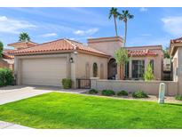 Single-story home with terracotta tile roof, well-manicured lawn, and desert landscaping at 6620 N 79Th Pl, Scottsdale, AZ 85250