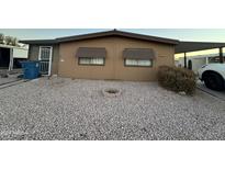 Tan single-wide manufactured home with gravel landscaping at 6723 W Fillmore St # 301, Phoenix, AZ 85043