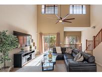 Spacious living room with high ceilings, large windows, and comfortable seating at 6940 E Cochise Rd # 1007, Paradise Valley, AZ 85253