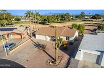 Single-story home with a large front yard, driveway, and desert landscaping at 713 S 81St Pl, Mesa, AZ 85208