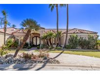 Spanish style home with palm trees, brick driveway, and landscaped yard at 9840 N 111Th Pl, Scottsdale, AZ 85259