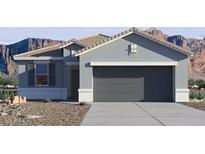 One-story home with gray exterior, two-car garage, and desert landscaping at 1829 W Spaulding Ave, Apache Junction, AZ 85120