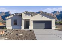 Single-story home with a two-car garage and desert landscaping at 9773 S Palo Verde Dr, Apache Junction, AZ 85120