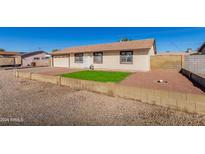 Single-story house with a well-maintained lawn and a gravel driveway at 11328 E Elton E Ave, Mesa, AZ 85208