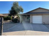 Ranch style home with attached garage and mature landscaping at 2415 W Kilarea Ave, Mesa, AZ 85202