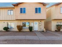 Tan two-story townhome with a small front yard and walkway at 3605 W Bethany Home Rd # 21, Phoenix, AZ 85019