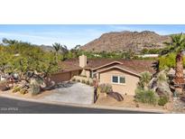 Single-story home with a tiled driveway, mature landscaping, and mountain views at 5635 E Lincoln Dr # 8, Paradise Valley, AZ 85253