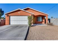 Single story home with attached garage and desert landscaping at 10638 N 15Th Ln, Phoenix, AZ 85029