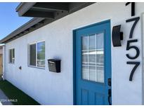 Updated home exterior with teal front door and modern house numbers at 1757 W Sunland Ave, Phoenix, AZ 85041