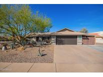 Single-story home with landscaped front yard, driveway, and two-car garage at 21002 N Totem Dr, Sun City West, AZ 85375