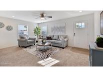 Bright living room features comfy seating, a coffee table, and large windows at 320 E Mckellips Rd # 128, Mesa, AZ 85201