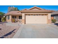 Single-story house with a two-car garage and desert landscaping at 6404 W Behrend Dr, Glendale, AZ 85308