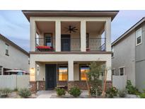 Two-story home with balcony and front yard landscaping at 15506 S 180Th Ln, Goodyear, AZ 85338