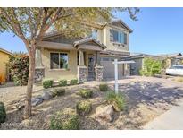 Two-story house with stone accents and a three-car garage at 25410 S 224Th Pl, Queen Creek, AZ 85142