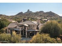 Luxury home with stone exterior, large driveway, and mountain views at 27939 N 100Th Pl, Scottsdale, AZ 85262