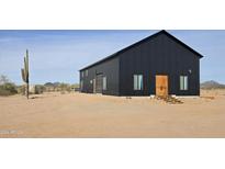 Modern black barn-style home with desert landscaping at 30314 W Wildcat Dr, Wittmann, AZ 85361
