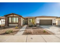 Single-story home with stone accents and a two-car garage at 39813 N Staman St, San Tan Valley, AZ 85140