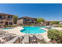 Community pool with lounge chairs and spa at 42424 N Gavilan Peak Pkwy # 42206, Anthem, AZ 85086