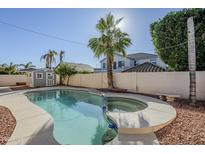 Inviting backyard pool and spa with storage shed at 9443 W Melinda Ln, Peoria, AZ 85382