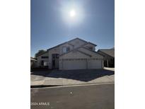 Two-story house with a three-car garage and desert landscaping at 5417 W Kerry Ln, Glendale, AZ 85308