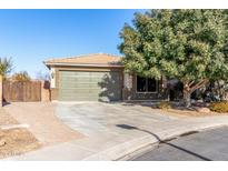 Single-story house with a two-car garage and landscaped front yard at 1026 W Dove Tree Ave, San Tan Valley, AZ 85140