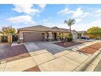 House exterior view, featuring a two-car garage and neatly landscaped front yard at 17867 W Eugene Ter, Surprise, AZ 85388