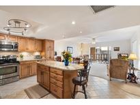 Kitchen features granite countertops, stainless steel appliances, and ample wood cabinetry at 7860 E Camelback Rd # 209, Scottsdale, AZ 85251