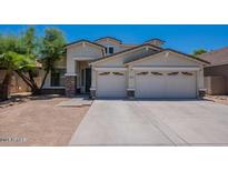 Two-story house with three-car garage and desert landscaping at 10419 E Kiva Ave, Mesa, AZ 85209