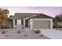 Single-story home with a two-car garage and desert landscaping at 12535 W Parkway Ln, Avondale, AZ 85323