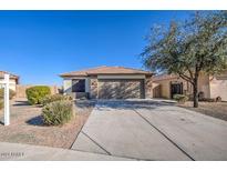 Single-story house with a two-car garage and landscaped front yard at 18485 N Miller Way, Maricopa, AZ 85139