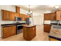 Spacious kitchen with island, stainless steel appliances, and ample wood cabinets at 9831 E Broadway Rd, Mesa, AZ 85208