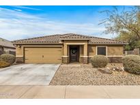 Single-story house with a two-car garage and well-maintained landscaping at 442 W Black Hawk Pl, Casa Grande, AZ 85122