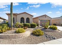 Landscaped front yard with desert landscaping and stone pathway at 16938 W Desert Rose Ln, Surprise, AZ 85387