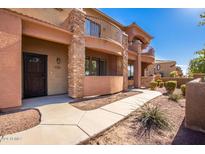 Two story stucco building with walkway and landscaping at 21655 N 36Th Ave # 137, Glendale, AZ 85308