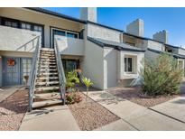 Well-maintained condo building with stairs leading to unit entrance and landscaping at 3716 E University Dr # 2014, Mesa, AZ 85205