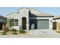 Single-story home with gray exterior, two-car garage, and landscaping at 40904 W Hillman Dr, Maricopa, AZ 85138