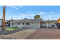 Updated single story home with carport and artificial turf at 4345 E Desert Cactus St, Phoenix, AZ 85032