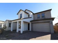 Two-story home with gray and white siding, a three-car garage, and a paved driveway at 22783 E Stacey Rd, Queen Creek, AZ 85142