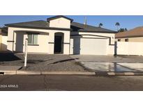 Newly built home with a two-car garage and a landscaped front yard at 4022 S 24Th Pl, Phoenix, AZ 85040