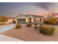 Single-story home with a two-car garage and desert landscaping at 29411 W Mitchell Ave, Buckeye, AZ 85396