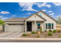 Craftsman style home with two-car garage and desert landscaping at 21354 W Minnezona Ave, Buckeye, AZ 85396